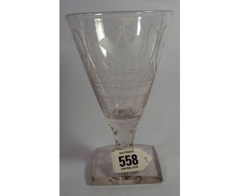 A clear glass runner or goblet standing on a square base, the glass decorated with masonic symbols, the compass, the square a