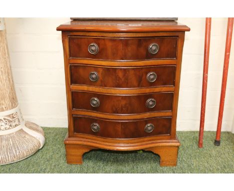 Serpentine chest of 4 drawers with metal drop handles over bracket feet 