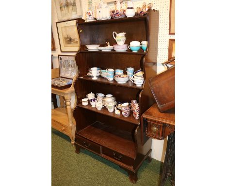 20thC Mahogany waterfall bookcase of 4 shelves with drawer base over bracket feet 