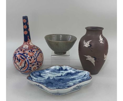 FOUR ASIAN CERAMICS, including Japanese Arita blue and white dish painted with a landscape, base with running Fuku mark, 21cm