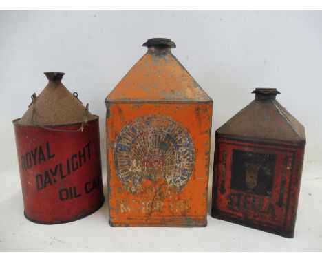 An SPBA Motor Oil pyramid can, a Stella Sanctuary Lamp Oil pyramid can and one other.
