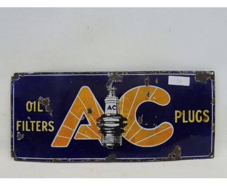 An AC Plugs and Oil Filters rectangular enamel sign with central plug image, 21 x 9". 