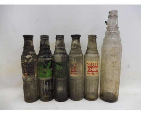 Three Shell X-100 Motor Oil pint glass bottles, two BP Energol bottles and one other.