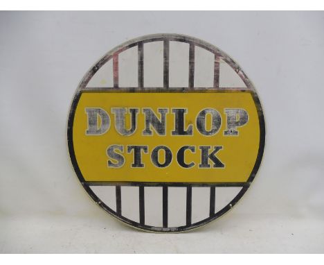 A Dunlop Stock circular tin advertising sign dated December 1951, 23 3/4" diameter.