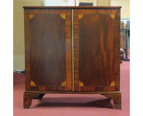 A Georgian inlaid two door mahogany cabinet, with marquetry fan paterae, on bracket feet, H.105 W.100 D.58cm 