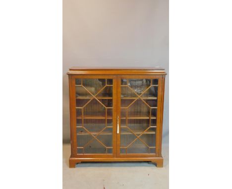 A Georgian style mahogany book case, with 2 astragal glazed doors, raised on bracket feet, H.114 W.108 D.30cm