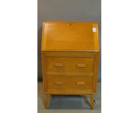 A mid 20th century light oak bureau, raised on splayed legs, H.104 W.62 D.41cm 