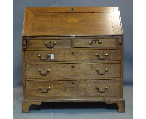 A 19th century oak bureau with marquetry inlay, raised on bracket feet, H.106 W.99 D.53cm 