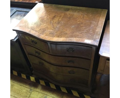 A reproduction stained walnut chest of two short and three graduated drawers, on shaped bracket feet, 70cm wide, together wit