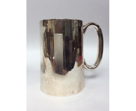 A Silver Christening tankard, of plain tapering cylindrical form with loop handle, Sheffield, 1962, 440g, 13cm high 