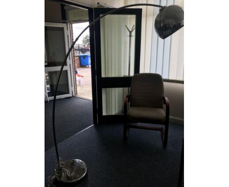 A chromium plated electric standard lamp, with suspended solid globular shade and long curved pole to a weighted circular bas