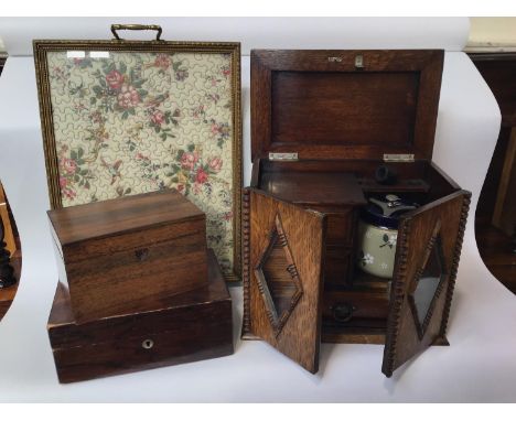 An oak smokers cabinet, with carved beaded edged doors, diamond shaped glazed panels opening to reveal a tobacco jar, and two