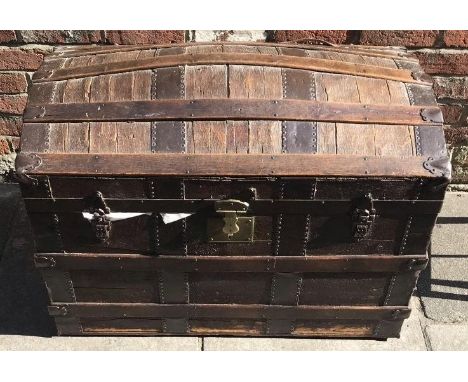 A 19th century wooden dome-topped trunk with metal bindings and fittings etc, (af), 93cm wide 