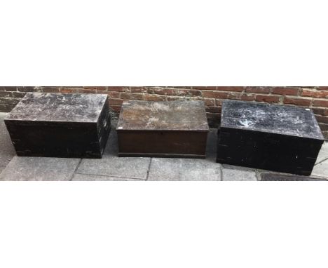 Two metal-bound black painted teak trunks, together with and oak-grained trunk, (3) 77cm wide 