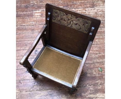 A single-seat stained oak 'Monk's Bench' by George Fleet &amp; Co Ltd, with gilt-tooled green leather writing scribe and gold