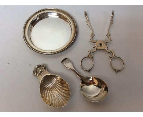 A George III silver fiddle pattern caddy spoon, and a shell-capped silver caddy spoon, together with a pair of late Georgian 