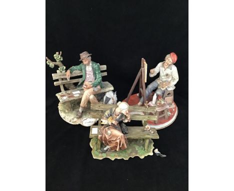 Three various Capodimonte 'vagabond' figures including an artist at his easel (af), 30cm high, a man playing cards on a bench