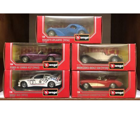 5 boxed Burago die cast scale 1:24 model cars including Bugatti Atlantic, Ford AC Cobra, BMW M3, Mercedes-Benz SSK &amp; Chev