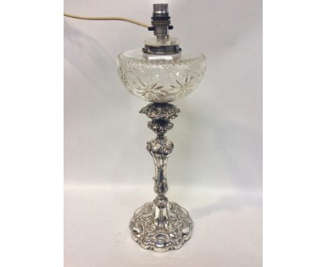 An Elkington &amp; Co electroplated oil lamp in the Rococo style, with cut glass reservoir, converted to electricity, 50cm hi