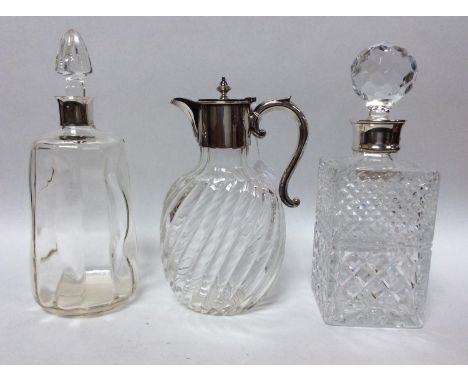 A Victorian glass claret jug with spiral reeded oval body, silver-plated handle and lidded spout, together with two silver-mo