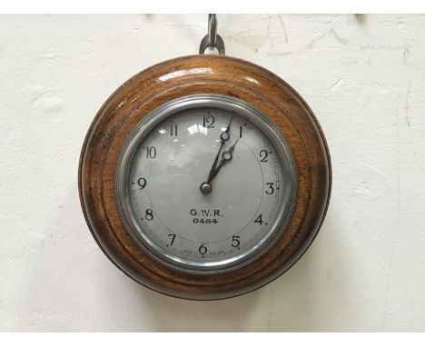 A GWR oak cased 'pork pie' clock, with white enamel dial, Arabic numerals, stamped 'G.W.R. 0484 Made in England', silvered ch