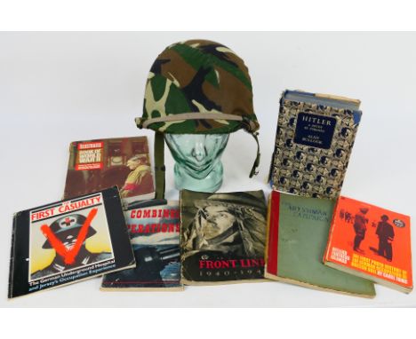 A replica World War Two (WW2 / WWII) American army helmet with glass display head and a quantity of military / WW2 related pu