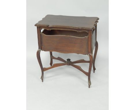 A Victorian mahogany serpentine card table, with four levered side playing shelves, raised on cabriole legs united by a X fra