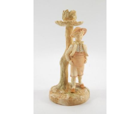 A Hadleys Worcester blush porcelain figural candlestick, circa 1886, modelled as a boy standing against an oak tree, impresse