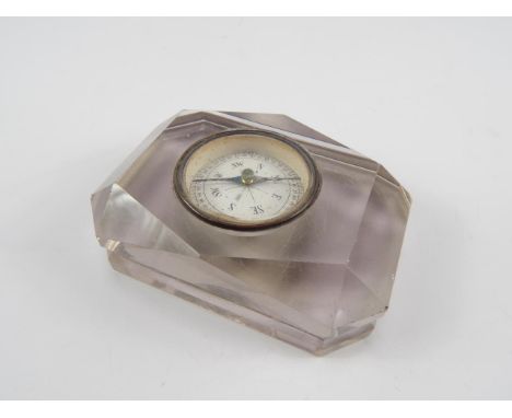 A Victorian faceted cut glass paperweight, of canted rectangular form set to the top with a compass, 10.5cm x 7cm.