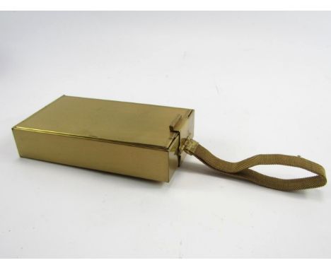 A Park Lane brass compact, with lipstick holders and integral cigarette case and match holder, with engine turned decoration,