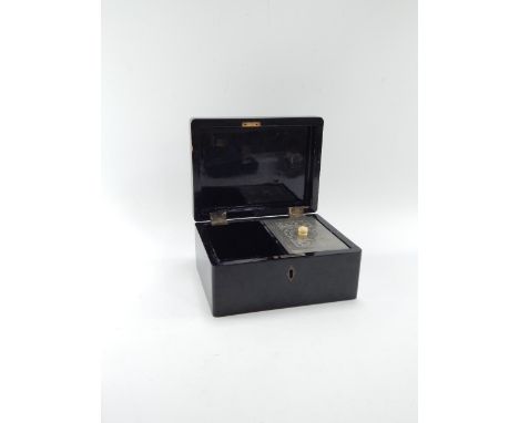 A Chinese late 19thC black lacquer twin division tea caddy, with a white metal cannister, 20cm x 15cm x 9.5cm.