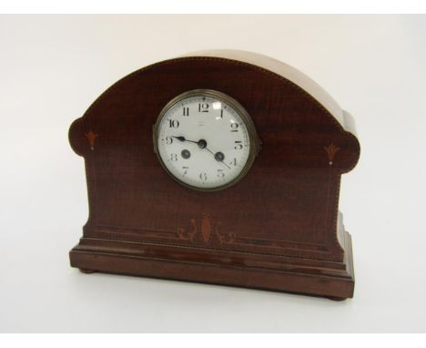 An Edwardian mahogany and inlaid mantel clock, enamel dial bearing Arabic numerals, French eight day movement, the cane with 