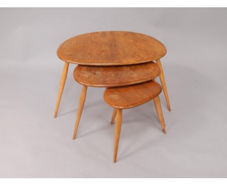 An Ercol nest of beech and elm kidney shaped occasional tables, largest 65cm x 44cm x 39cm.