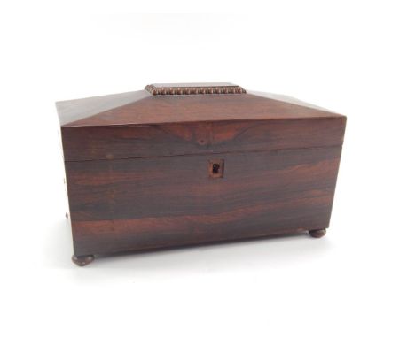 A Regency rosewood sarcophagus tea caddy, the three section interior having two metal cannisters flanking a glass mixing bowl