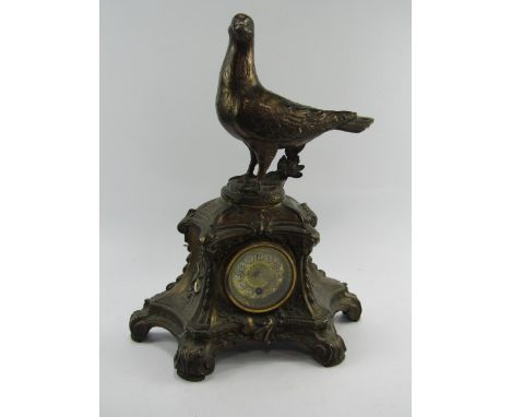 A Continental late 19thC cast metal mantel clock, brass dial bearing Arabic numerals, thirty hour movement, the case of rococ