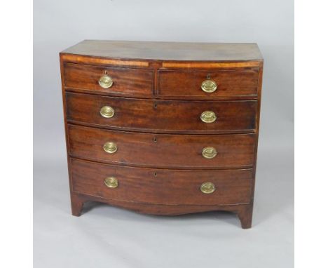 A George III mahogany bow front chest of drawers, with satinwood banding, two short and three long graduated drawers, raised 