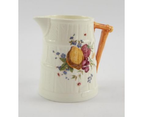 A Royal Worcester porcelain cream jug, of barrel form painted with fruit, printed mark, 11cm high.