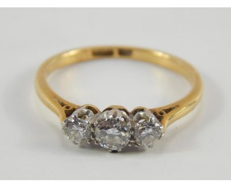 An 18ct gold and diamond three stone ring, approx 1/4ct, size K, 2.1g.