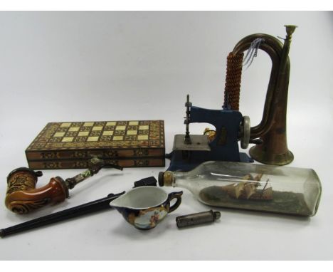 An Enfield bayonet, bugle, ship in a bottle, child's sewing machine, Meissen porcelain cream jug, Schrader tyre gauge, and a 