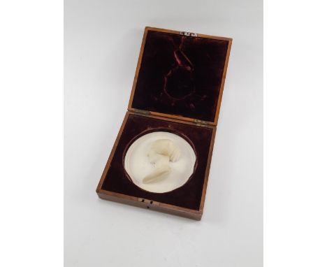 A Victorian circular alabaster plaque, bust portrait of a lady, possibly Queen Victoria, signed Insom Fece, walnut cased, pla