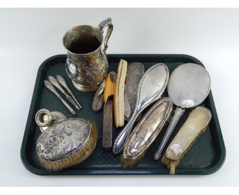 A group of silver back hair brushes, clothes brushes, hand mirror and manicure implements, silver candlestick, all for scrap,