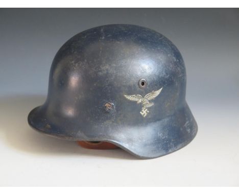 A WWII German Luftwaffe DD helmet with early Eagle transfer, rim stamped Q62 &amp; T605, with chin strap 