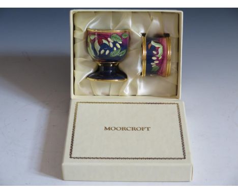 A Modern Moorcroft Enamel Egg Cup and Napkin Ring Boxed Set decorated with berries, dated 03 