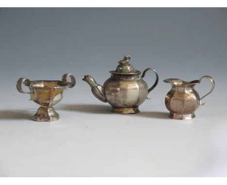 A Dutch Silver Dolls House Miniature Three Part Tea Set, the teapot with swan finial and mask spout, teapot 2.5cm high, 12.6g