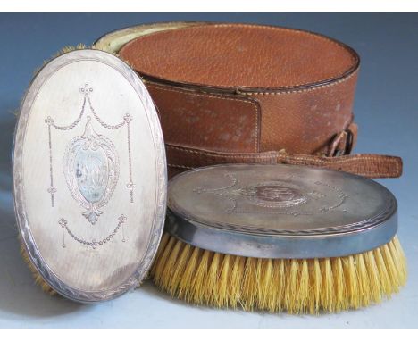 A Leather Cased Pair of George V Silver Backed Brushes with engine turned, punched swag and chased decoration, London 1919, C