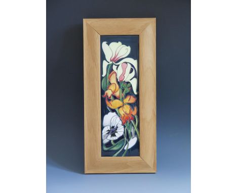 A Modern Moorcroft Miss Alice Pattern Plaque dated 2005 and framed by The Art Studio, 40x19cm overall size 