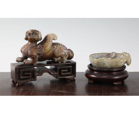Two Chinese bowenite jade carvings, 20th century, the first an archaistic recumbent figure of bixi, greenish yellow and brown