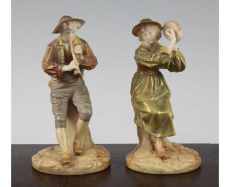 Two Royal Worcester shot enamels figures of a shepherd and shepherdess, modelled by James Hadley, playing a piccolo and a tam