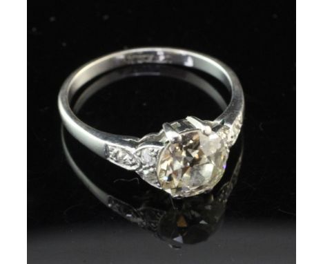 An 18ct white gold and platinum single stone diamond ring with diamond set shoulders, the oval cut stone approximately measur