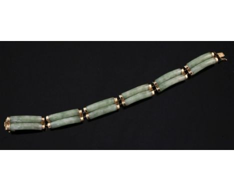 A Chinese 14ct gold mounted jade bracelet, with six links comprising two jade curved batons, 7in.